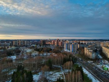 High angle view of illuminated city buildings against sky