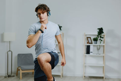 Portrait of young woman exercising in gym