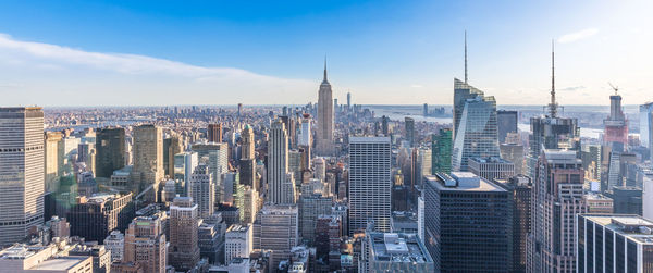 Aerial view of buildings in city against sky