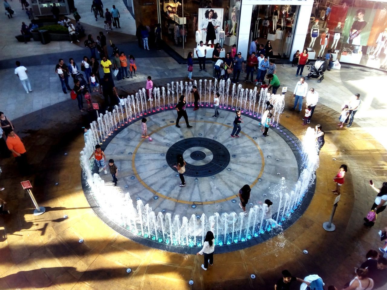 HIGH ANGLE VIEW OF PEOPLE WALKING IN CORRIDOR