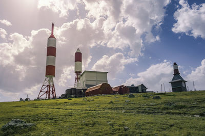 Built structure on field against sky