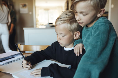 Portrait of boy using laptop at home