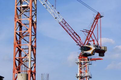 Low angle view of crane against sky