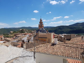 Traditional building by mountains against sky