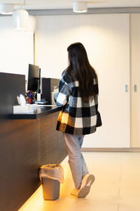 A young girl pays at the counter at the hospital reception.