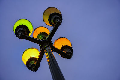 Low angle view of illuminated street light against sky