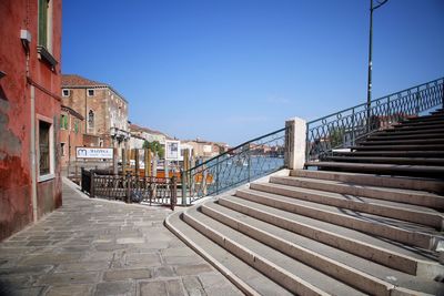 Staircase in city against clear sky