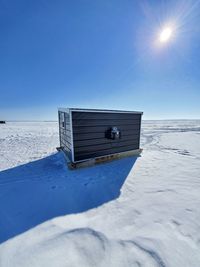 Ice fishing cabin in the middle of a frozen lake