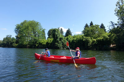 Two children canoing on the river lot in the aquitaine region of france