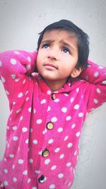 Portrait of cute girl against wall