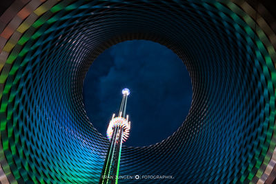 Low angle view of illuminated lighting equipment at night