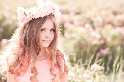 Teenager girl wearing wreath standing at farm
