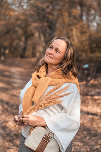 Woman standing in park during autumn