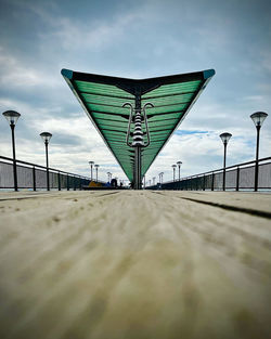 Surface level of bridge over sea against sky