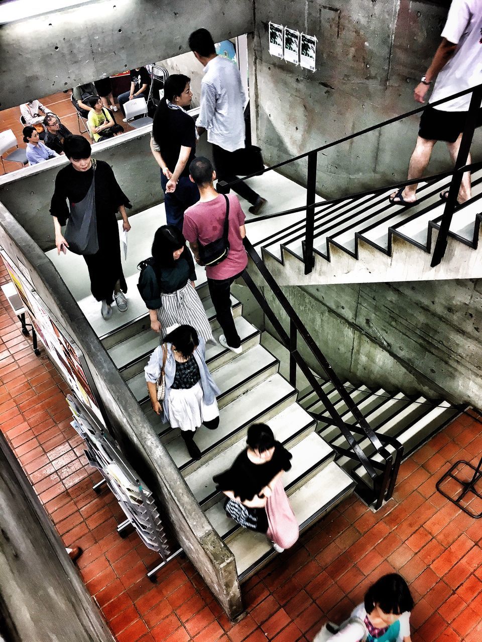 HIGH ANGLE VIEW OF PEOPLE SITTING ON STEPS