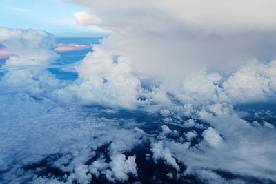  clouds formation in the blue sky, view from aircraft porthole