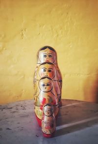 Close-up of toy statue against wall