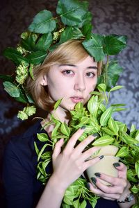 Portrait of a girl with green leaves