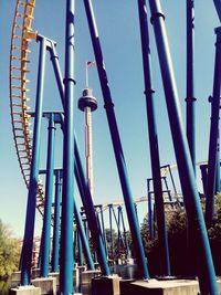 Low angle view of chain swing ride against clear blue sky