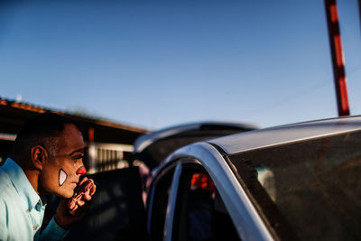 Man using smart phone against sky