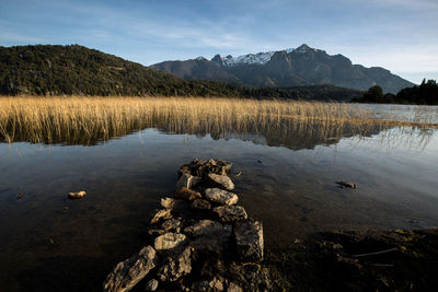 Scenic view of lake and mountains against sky