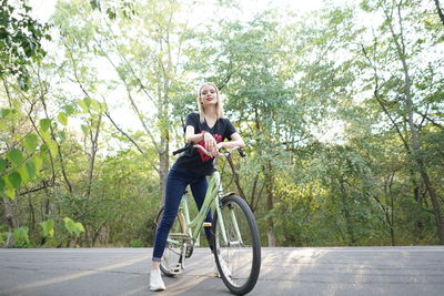Rear view of man riding bicycle on road