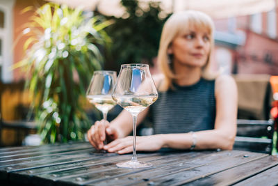 Mature woman looking away while sitting at cafe