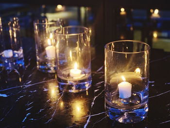 Lit tea light candles in temple