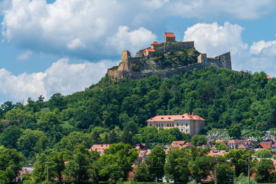 Buildings in town against sky