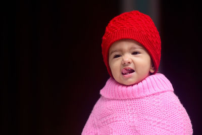 Baby girl wearing winter woolen knitted cap and poncho