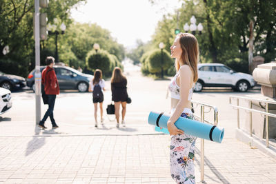 People walking on footpath in city