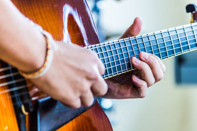 Close-up of man playing guitar