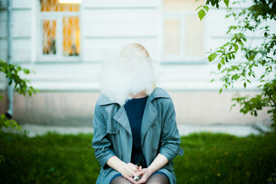 Young woman smoking electronic cigarette