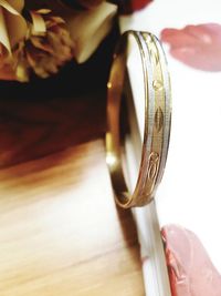 Close-up of engagement ring by book on table