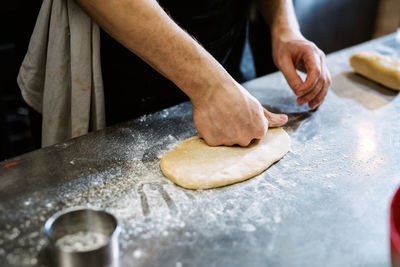 Midsection of man preparing food on table