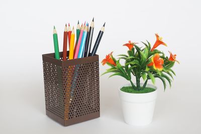 Close-up of multi colored pencils on white table