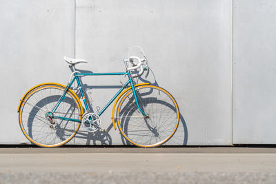 Bicycle against wall in city