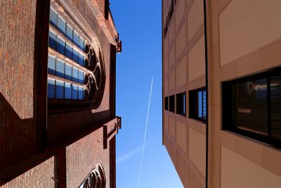 Low angle view of buildings against clear blue sky