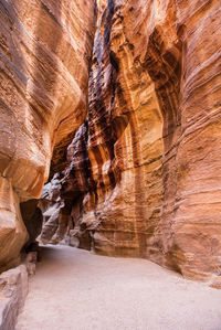 Low angle view of pathway amidst rock formations