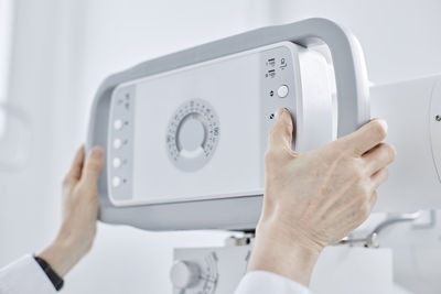 Hands of radiologist adjusting x-ray machine