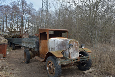 Abandoned vintage car on field