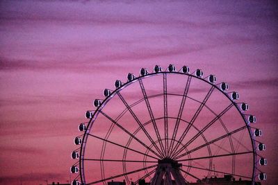 Low angle view of ferris wheel against sky