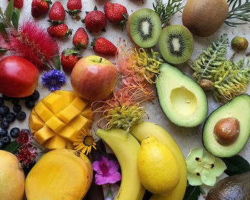 High angle view of fruits and flowers on stone table 