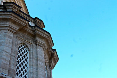 Low angle view of building against clear blue sky