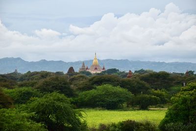Panoramic view of trees and buildings against sky