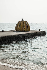 Lifeguard hut on beach against clear sky