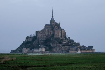 Church on field against clear sky le mont saint michel