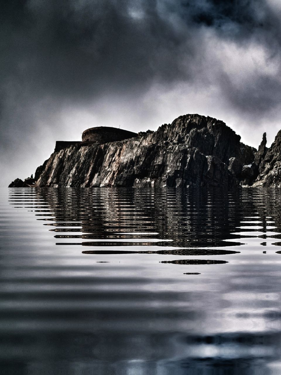 SURFACE LEVEL OF ROCK FORMATION IN LAKE AGAINST SKY