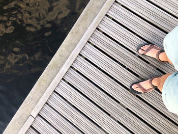 Low section of woman standing on wooden floor