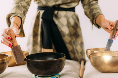 Woman playing tibetan singing bowl in sound healing therapy